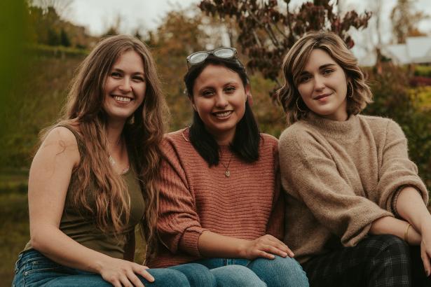 Drie vrouwen zitten op een rij